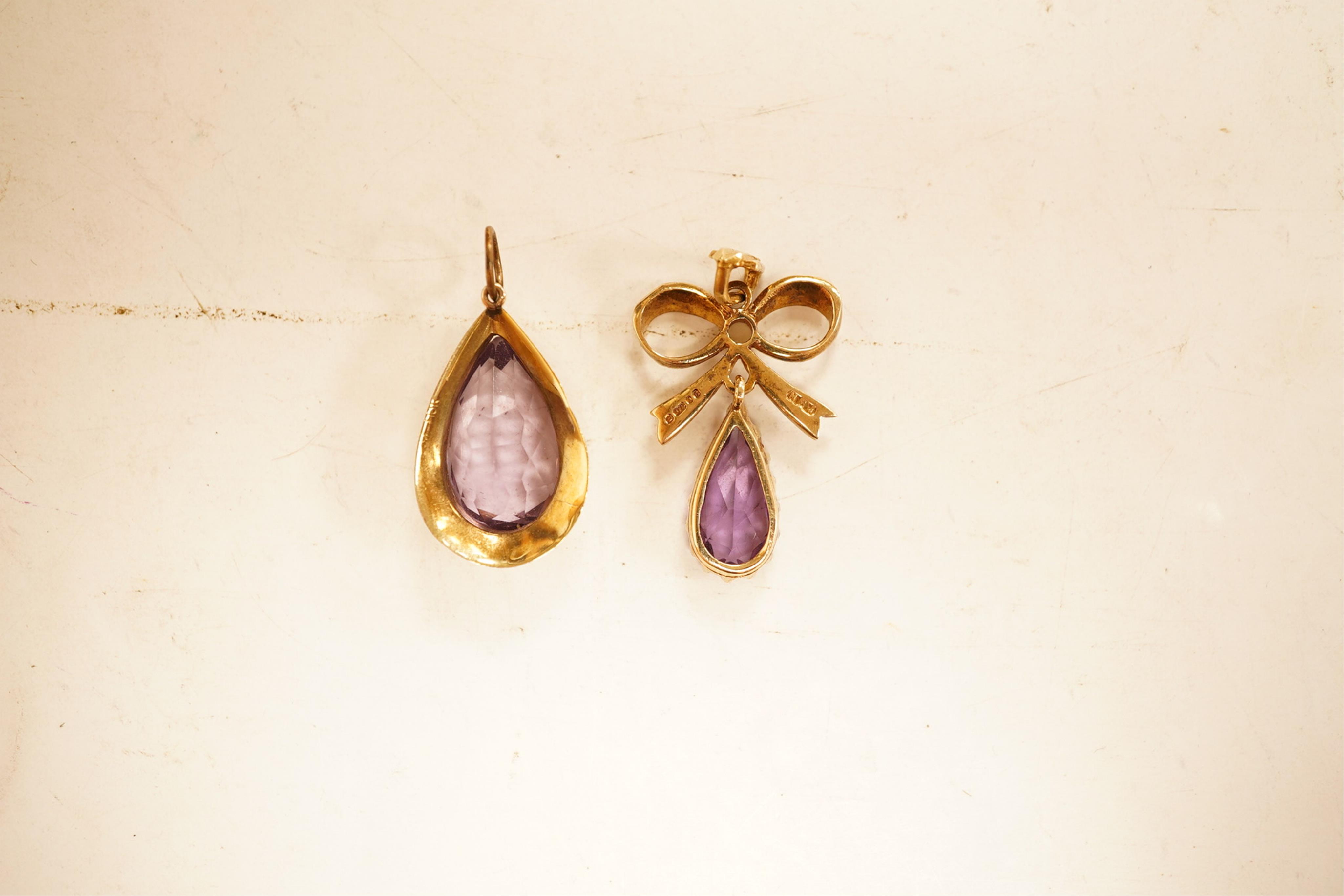 A 1970's 9ct gold, amethyst and seed pearl set drop pendant, 29mm, together with a yellow meta and amethyst set drop pendant.